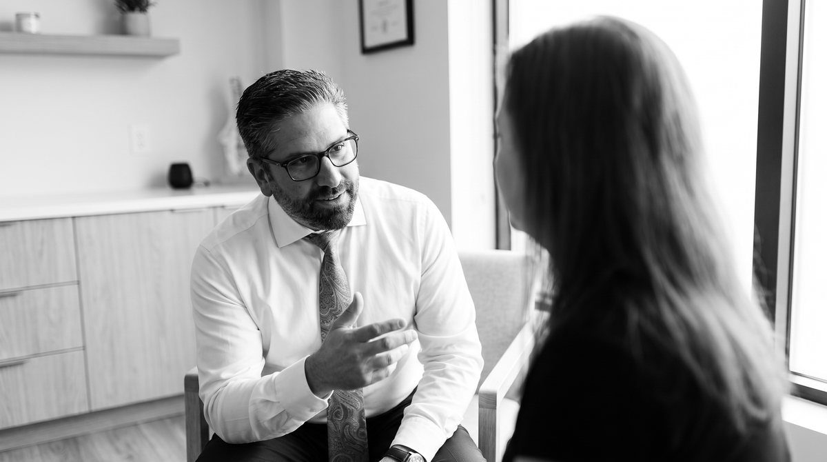 Dr. Jonathan Lazar, D.C. talking with a patient during a consultation